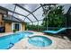 Tranquil screened pool and spa with plenty of space for relaxation at 957 Westwinds Blvd, Tarpon Springs, FL 34689
