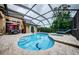 Private screened pool and spa with tiled accents and lounge chairs at 957 Westwinds Blvd, Tarpon Springs, FL 34689