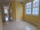 Bedroom featuring tile floors and a large window with natural light at 1768 Lago Vista, Palm Harbor, FL 34685