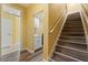 Hallway with staircase leading to upstairs rooms and a laundry room at 1768 Lago Vista, Palm Harbor, FL 34685