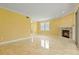 Living room features a fireplace and sliding glass door to the lanai and a lake view at 1768 Lago Vista, Palm Harbor, FL 34685