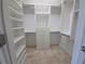 Well-organized walk-in closet with shelving, drawers, closet rods and marble flooring at 1768 Lago Vista, Palm Harbor, FL 34685