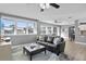 Open-concept living room featuring large windows, modern furniture, and a seamless flow to the dining area at 450 82Nd Ave, St Pete Beach, FL 33706