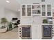Modern wet bar with glass-front cabinets, wine cooler, and ice maker at 920 N Osceola Ave # 201, Clearwater, FL 33755