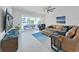 Spacious living room with sectional sofa, large TV, and balcony access at 920 N Osceola Ave # 201, Clearwater, FL 33755