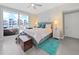 Bedroom with queen-size bed, balcony access, and teal rug at 920 N Osceola Ave # 201, Clearwater, FL 33755