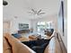 Tan leather sectional sofa and large TV in a bright living room at 920 N Osceola Ave # 201, Clearwater, FL 33755