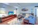 Living room with hardwood floors, sectional sofa, and large TV at 1655 S Highland Ave # B216, Clearwater, FL 33756
