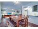 Bright dining area with wood table and bench seating, hardwood floors, and adjacent living space at 1655 S Highland Ave # B216, Clearwater, FL 33756