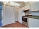 Updated kitchen featuring stainless steel appliances and white cabinets at 1655 S Highland Ave # B216, Clearwater, FL 33756