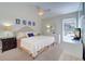 Main bedroom with king-size bed, dresser, and ceiling fan at 1655 S Highland Ave # B216, Clearwater, FL 33756