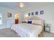 Main bedroom with king-size bed, dresser, and ceiling fan at 1655 S Highland Ave # B216, Clearwater, FL 33756