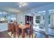 Dining area with table and chairs, built-in shelving, and view into adjacent sunroom at 1655 S Highland Ave # B216, Clearwater, FL 33756