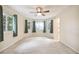 Bright bedroom featuring a ceiling fan and a walk-in closet at 2327 Spring Lake Hwy, Brooksville, FL 34602