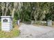 Long driveway leading to a home with gated entrance at 2327 Spring Lake Hwy, Brooksville, FL 34602