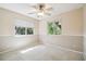 Cozy carpeted bedroom with ceiling fan and neutral color walls at 2327 Spring Lake Hwy, Brooksville, FL 34602