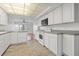 White kitchen with gray countertops and tile floor. Features a breakfast bar at 5080 Locust Ne St # 329, St Petersburg, FL 33703