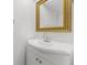 White vanity with curved countertop, modern faucet, and ornate gold framed mirror at 5080 Locust Ne St # 329, St Petersburg, FL 33703