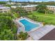 Community pool with lounge chairs and surrounding landscaping at 5080 Locust Ne St # 329, St Petersburg, FL 33703