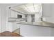 White kitchen with gray countertops, breakfast bar, and tile floor at 5080 Locust Ne St # 329, St Petersburg, FL 33703