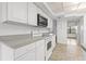 White kitchen with gray countertops, microwave, oven, and tile floor at 5080 Locust Ne St # 329, St Petersburg, FL 33703
