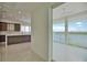 Hallway view of kitchen and water view from sliding glass doors at 13064 Via Flavia, Placida, FL 33946
