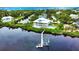 Waterfront home with private dock and pool; lush landscaping at 13064 Via Flavia, Placida, FL 33946