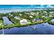 Stunning waterfront home with private dock and pool, surrounded by lush greenery at 13064 Via Flavia, Placida, FL 33946