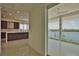 Hallway view of kitchen and water view from sliding glass doors at 13064 Via Flavia, Placida, FL 33946