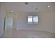 Bright and airy bedroom with tile flooring and access to another room at 13064 Via Flavia, Placida, FL 33946