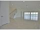 Spacious living area with tile floors and modern staircase at 13064 Via Flavia, Placida, FL 33946