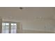 Bright and airy living room with tile floors and access to a balcony at 13064 Via Flavia, Placida, FL 33946
