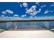 Private balcony overlooking the water with glass railings at 13064 Via Flavia, Placida, FL 33946