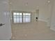 Bright living room with large windows,water views, and tile floors at 13064 Via Flavia, Placida, FL 33946