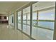 Living room with sliding glass doors leading to a waterfront patio at 13064 Via Flavia, Placida, FL 33946