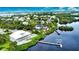 Aerial view of waterfront home with private dock and pool; lush landscaping at 13064 Via Flavia, Placida, FL 33946