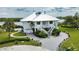 Two-story waterfront home with circular driveway and lush landscaping at 13064 Via Flavia, Placida, FL 33946