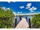 Long wooden dock extending over calm water at 13064 Via Flavia, Placida, FL 33946