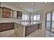 Modern kitchen with island, stainless steel appliances, and water views at 13064 Via Flavia, Placida, FL 33946