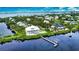 Waterfront property with a private dock, pool, and lush landscaping at 13064 Via Flavia, Placida, FL 33946
