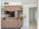Kitchen boasts a breakfast bar and wood cabinets at 1884 Dolphin S Blvd, St Petersburg, FL 33707