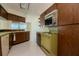 Retro kitchen with wood cabinets and built-in microwave at 1884 Dolphin S Blvd, St Petersburg, FL 33707