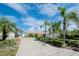 Attractive mid-century modern home with palm trees and a long driveway at 1884 Dolphin S Blvd, St Petersburg, FL 33707