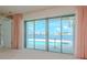 Living room with sliding glass doors offering scenic water views at 1884 Dolphin S Blvd, St Petersburg, FL 33707