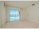 Bright bedroom with sliding glass doors to a pool and canal view at 1884 Dolphin S Blvd, St Petersburg, FL 33707
