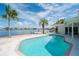 Inviting pool and patio area overlooking the water with a private dock at 1884 Dolphin S Blvd, St Petersburg, FL 33707
