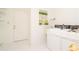 Bright laundry room with washer, dryer, and storage at 1884 Dolphin S Blvd, St Petersburg, FL 33707