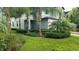 Modern house exterior with lush landscaping and palm trees at 7643 Ginger Lily Ct, Tampa, FL 33619