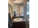 Bathroom with granite countertop, single sink vanity, and toilet at 7643 Ginger Lily Ct, Tampa, FL 33619