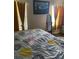 Serene bedroom featuring a king bed, wood-look flooring, and ample natural light at 7643 Ginger Lily Ct, Tampa, FL 33619